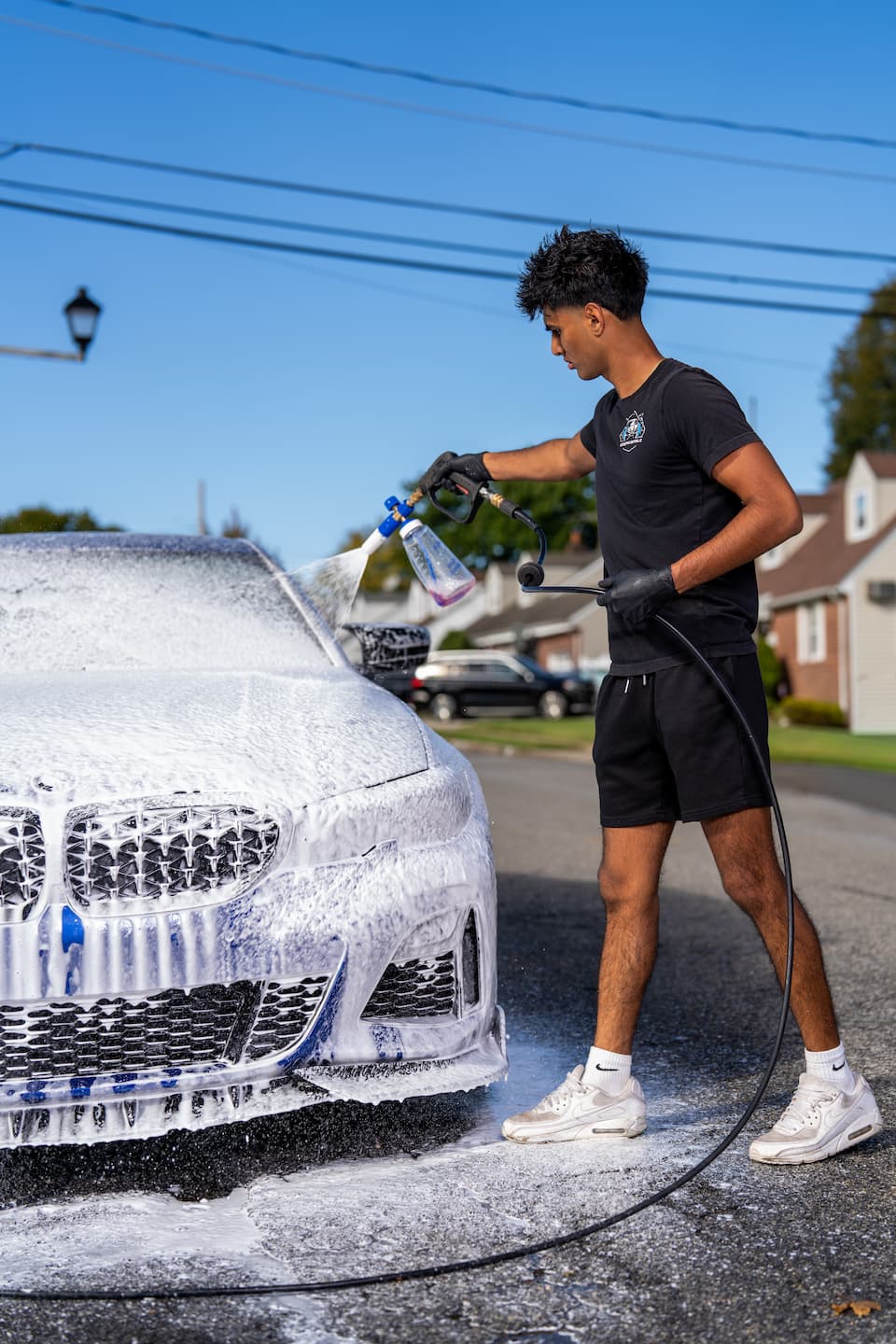 Autospa Detailz technician detailing a luxury vehicle in the Mineola, NY shop