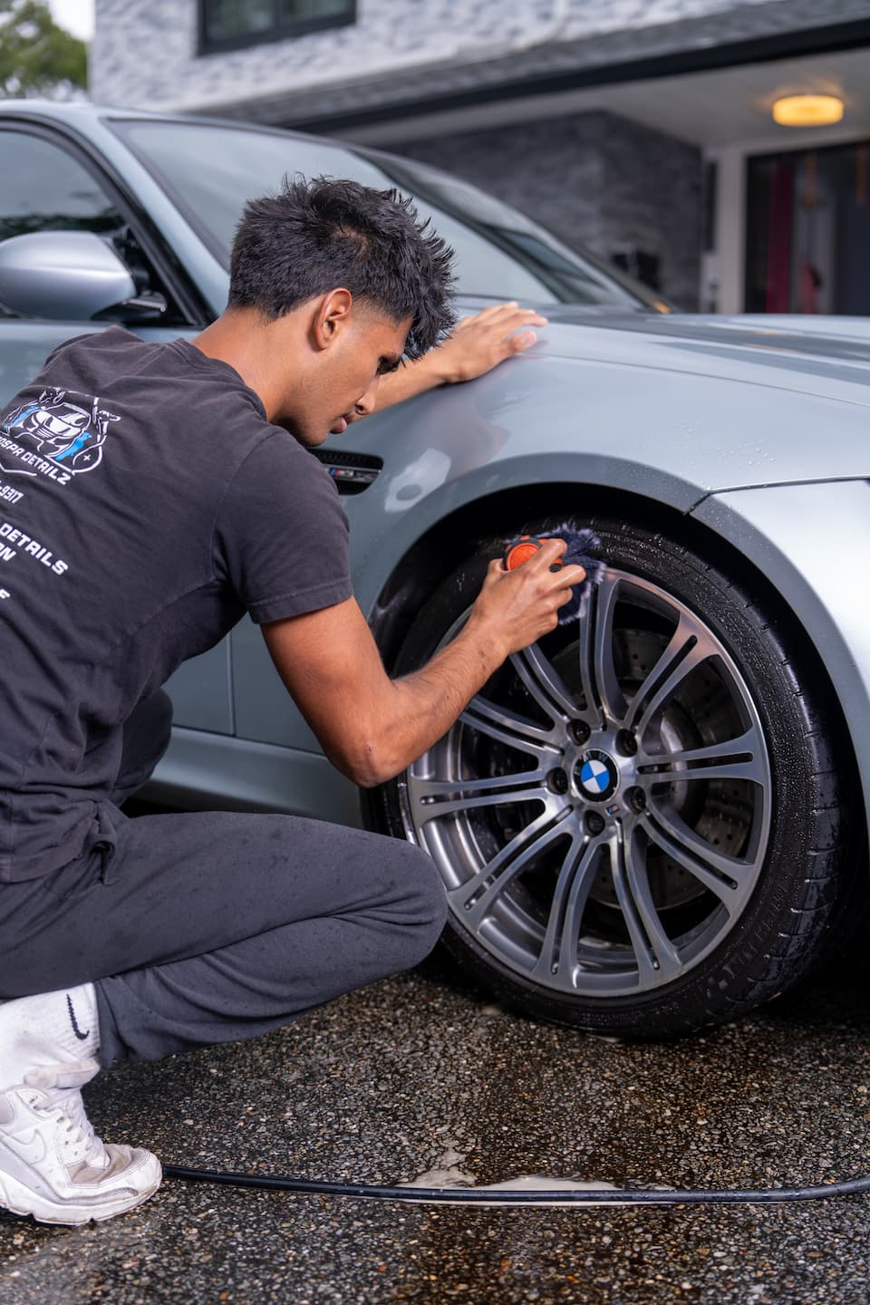 Autospa Detailz technician detailing a luxury vehicle in the Mineola, NY shop